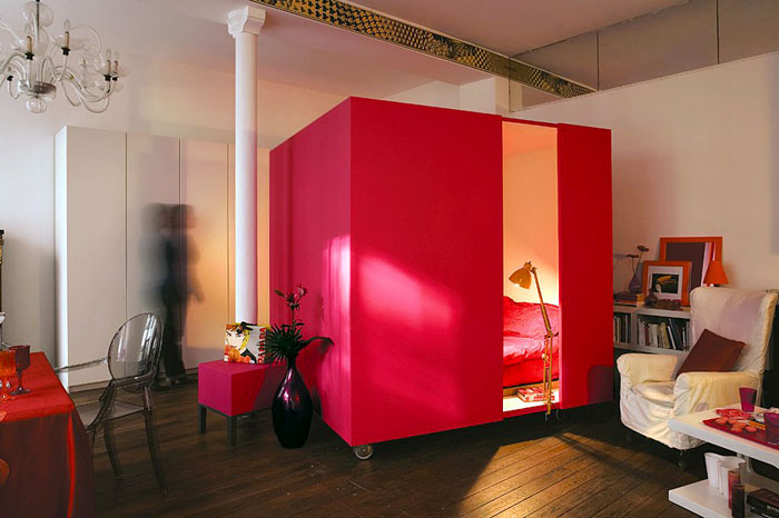 bed in red box small studio apartment