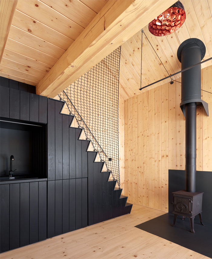 black kitchen under the stairs wood cabin