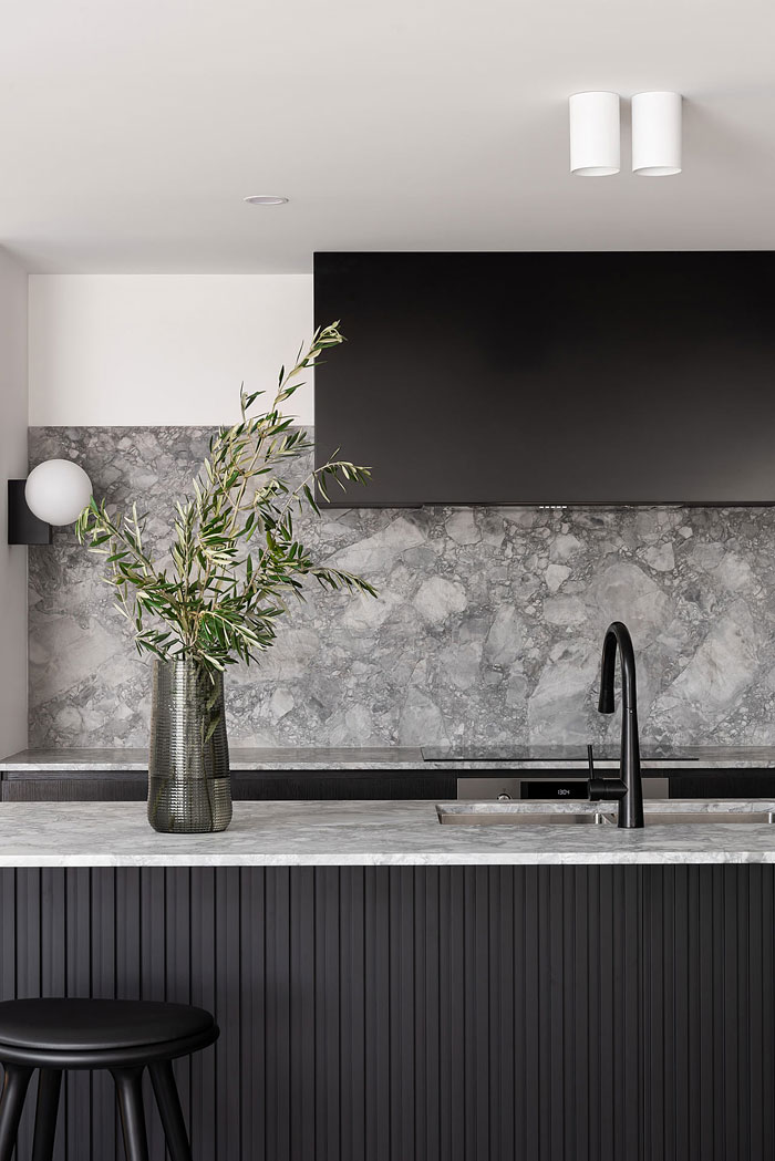 gray marble backsplash black kitchen cabinets